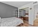 Bedroom featuring hardwood floors, gray accent wall, and mirrored closet doors at 13950 E Oxford Pl # A-104, Aurora, CO 80014