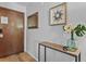 Condo entrance featuring wood-look flooring and a side table at 13950 E Oxford Pl # A-104, Aurora, CO 80014