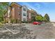 Wide view of the condo exterior showing balconies, parking, and landscaping in a well-maintained community at 13950 E Oxford Pl # A-104, Aurora, CO 80014
