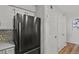 Updated kitchen features stainless steel refrigerator, white cabinets, hardwood floors, and stainless steel hardware at 13950 E Oxford Pl # A-104, Aurora, CO 80014