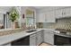 Cozy kitchen featuring diamond patterned backsplash, stainless steel appliances, and ample natural light at 13950 E Oxford Pl # A-104, Aurora, CO 80014