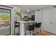 Open kitchen area with stainless steel appliances, breakfast bar with seating, and sliding door to the outside at 13950 E Oxford Pl # A-104, Aurora, CO 80014