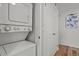 Convenient in-unit laundry with stacked washer and dryer near the entrance at 13950 E Oxford Pl # A-104, Aurora, CO 80014