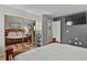 Main bedroom featuring a closet with mirrors, hardwood floors, and dark accent wall at 13950 E Oxford Pl # A-104, Aurora, CO 80014