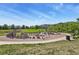 View of the community playground equipment with climbing structures, swings, and a slide in a Gathering-friendly area at 13950 E Oxford Pl # A-104, Aurora, CO 80014