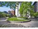 Beautifully landscaped courtyard with circular garden beds and mature trees provides a serene setting at 1625 Larimer St # 3004, Denver, CO 80202