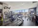 Modern gym with treadmills, elliptical machines, and panoramic city views at 1625 Larimer St # 3004, Denver, CO 80202