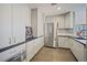 Modern kitchen featuring stainless steel appliances and sleek white cabinetry at 1625 Larimer St # 3004, Denver, CO 80202