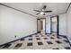 Bedroom with ceiling fan, tiled floors, and multiple doorways to other rooms and closet space at 8822 E Florida Ave # G07, Denver, CO 80247