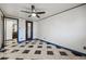 Spacious bedroom with tiled floors and a ceiling fan, complemented by doors leading to additional rooms at 8822 E Florida Ave # G07, Denver, CO 80247