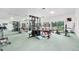 Spacious exercise room with fitness equipment and a large window with a treed backyard view at 8822 E Florida Ave # G07, Denver, CO 80247