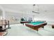 Community game room equipped with two pool tables, windows, and access to an outdoor patio at 8822 E Florida Ave # G07, Denver, CO 80247