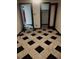 Hallway featuring distinctive black and white checkered tile flooring and paneled doors at 8822 E Florida Ave # G07, Denver, CO 80247