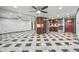 Spacious kitchen boasts stainless steel appliances, dark wood cabinetry and distinctive black and white tile floors at 8822 E Florida Ave # G07, Denver, CO 80247