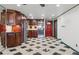 Bright kitchen with dark wood cabinets, stainless steel appliances, and unique black and white checkered flooring at 8822 E Florida Ave # G07, Denver, CO 80247