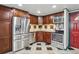 This kitchen features stainless appliances, dark wood cabinetry and unique black and white checkered flooring at 8822 E Florida Ave # G07, Denver, CO 80247