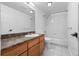 Clean bathroom with a single vanity, tub-shower combo, and tiled walls, providing a functional space at 7700 E 29Th Ave # 102, Denver, CO 80238