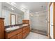 Bathroom with double vanity, granite counters, and a glass-enclosed shower, offering a clean, modern look at 7700 E 29Th Ave # 102, Denver, CO 80238