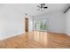 Bright bedroom featuring hardwood floors, white walls, and large windows with shutter-style blinds at 7700 E 29Th Ave # 102, Denver, CO 80238
