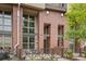 Brick condo exterior featuring a front patio, tall windows and architectural metal accents at 7700 E 29Th Ave # 102, Denver, CO 80238