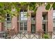 Brick condo building with metal accents and front patios surrounded by lush, manicured landscaping at 7700 E 29Th Ave # 102, Denver, CO 80238