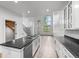 Spacious kitchen with stainless steel appliances, granite countertops, and a kitchen island with bar seating at 7700 E 29Th Ave # 102, Denver, CO 80238
