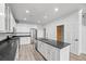 Modern kitchen with stainless steel appliances, granite countertops, and an island with a sink and a door at 7700 E 29Th Ave # 102, Denver, CO 80238