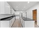 Well-equipped kitchen with modern appliances, sleek countertops, and an island featuring a sink at 7700 E 29Th Ave # 102, Denver, CO 80238