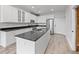 Modern kitchen with stainless steel appliances, granite countertops, and an island with a sink at 7700 E 29Th Ave # 102, Denver, CO 80238