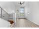 Bright living room featuring hardwood floors, a ceiling fan, and multiple windows for ample natural light at 7700 E 29Th Ave # 102, Denver, CO 80238