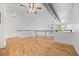 Open loft area with hardwood floors, white walls, a ceiling fan, and a modern, industrial-style design at 7700 E 29Th Ave # 102, Denver, CO 80238