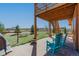 A backyard area offers rocking chairs and a grill for enjoyment of the outdoor space at 11524 Spruce Mountain Rd, Larkspur, CO 80118