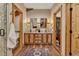 This bathroom features wood cabinets, dual sinks, granite countertops, and access to a walk-in closet at 11524 Spruce Mountain Rd, Larkspur, CO 80118