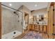 A stylish bathroom features a glass enclosed shower, wooden cabinets and granite countertops at 11524 Spruce Mountain Rd, Larkspur, CO 80118