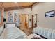 Cozy bedroom featuring two beds, wood-look floors, and colorful artwork, exuding a warm and inviting atmosphere at 11524 Spruce Mountain Rd, Larkspur, CO 80118