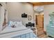 Charming bedroom with wood floors, vaulted wood ceiling, decorative desk, and bright light at 11524 Spruce Mountain Rd, Larkspur, CO 80118