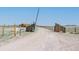 A long private driveway leads to this home through wooden gates and open pasture at 11524 Spruce Mountain Rd, Larkspur, CO 80118