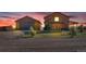 Exterior view of a barn and garage on a property with a dirt driveway, set against a colorful sunset sky at 11524 Spruce Mountain Rd, Larkspur, CO 80118