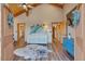 This hallway features wooden ceilings, hardwood floors, a cowhide rug, and a blue cabinet at 11524 Spruce Mountain Rd, Larkspur, CO 80118