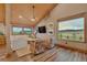Comfortable living room with a vaulted ceiling, wood floors, neutral decor and a scenic view through large windows at 11524 Spruce Mountain Rd, Larkspur, CO 80118