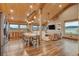 Open-concept living space with vaulted wood ceiling, wood floors, views of land, and comfortable seating at 11524 Spruce Mountain Rd, Larkspur, CO 80118