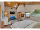 This main bedroom includes high ceilings, a ceiling fan, an artistic wall painting, and wood flooring at 11524 Spruce Mountain Rd, Larkspur, CO 80118