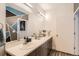 A well-lit bathroom with large mirror, double sinks and modern vanity at 8475 E 36Th Ave # 337, Denver, CO 80238