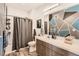 A bathroom with shower/tub combo, geometric wall and vanity with sink at 8475 E 36Th Ave # 337, Denver, CO 80238