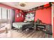 Modern bedroom with a large window, contemporary furnishings, and a red accent wall at 8475 E 36Th Ave # 337, Denver, CO 80238