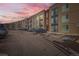Apartment building exterior featuring tan siding and black trim with ample parking on a cloudy day at 8475 E 36Th Ave # 337, Denver, CO 80238