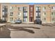 Modern apartment building exterior with designated parking spaces and convenient access to residential units at 8475 E 36Th Ave # 337, Denver, CO 80238