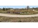 Scenic green space with a paved walking path, pond, and lush vegetation, offering a peaceful outdoor retreat at 8475 E 36Th Ave # 337, Denver, CO 80238