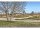 Picturesque view of a green space with a paved path, pond, and trees, ideal for leisurely walks and outdoor activities at 8475 E 36Th Ave # 337, Denver, CO 80238