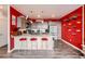 Modern kitchen with an eat-in island, updated appliances and red accent wall at 8475 E 36Th Ave # 337, Denver, CO 80238